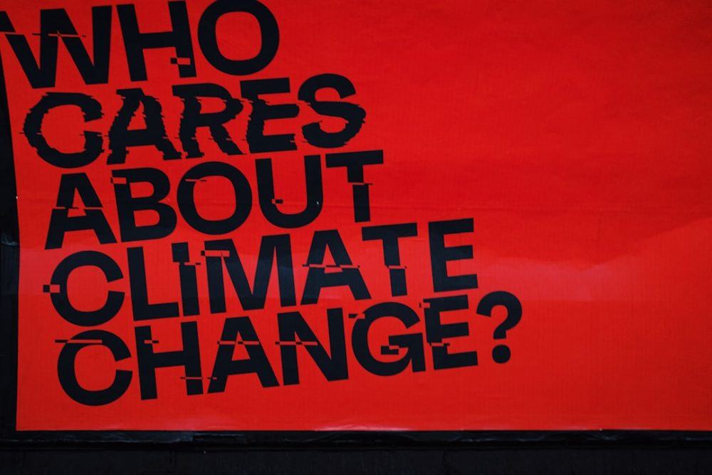 a red sign that says who cares about climate change?
